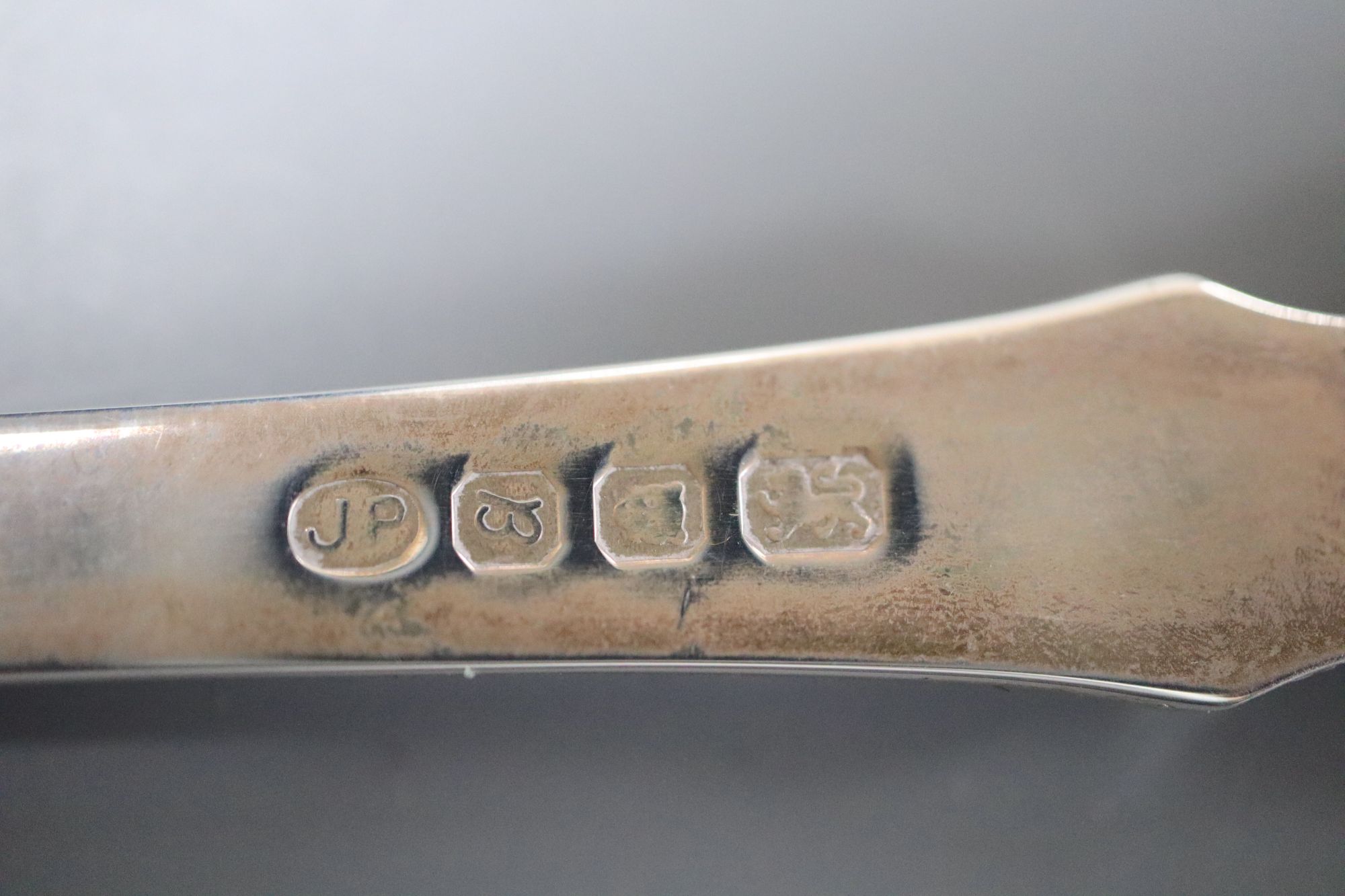 A cased set of 6 pairs of silver handled dessert knives & forks, a Peter Jackson Christmas spoon and a set of plated table knives